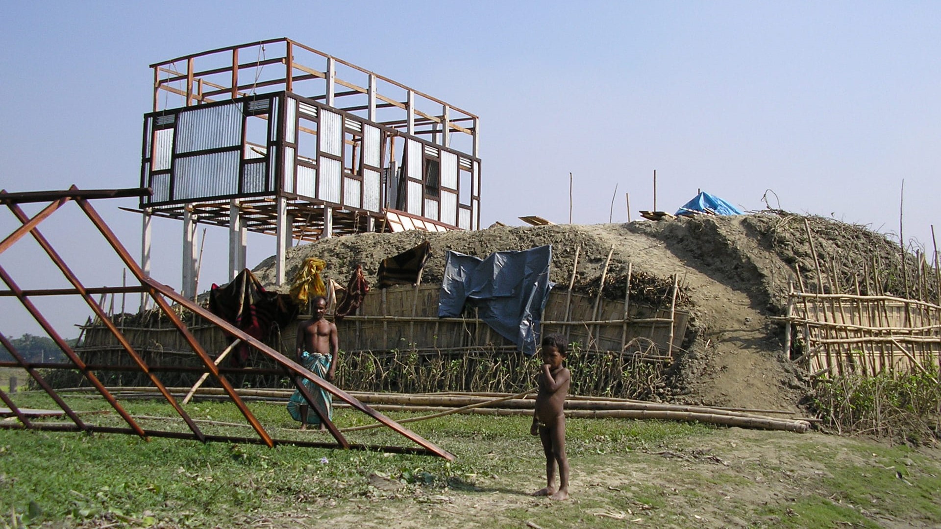 House being built on stilts on an earthen mound in Bangladesh